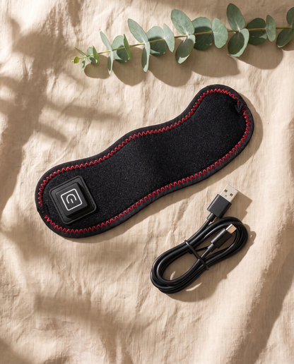 The Sinuglow wrap flat on linen with its USB C cable